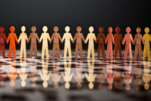 Understanding Critical Theory 18 a paper chain of stick figures reflecting on a surface.