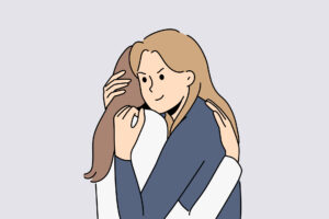 5 Signs of a Fake Friend 3 Two women hugging while one has a malicious facial expression