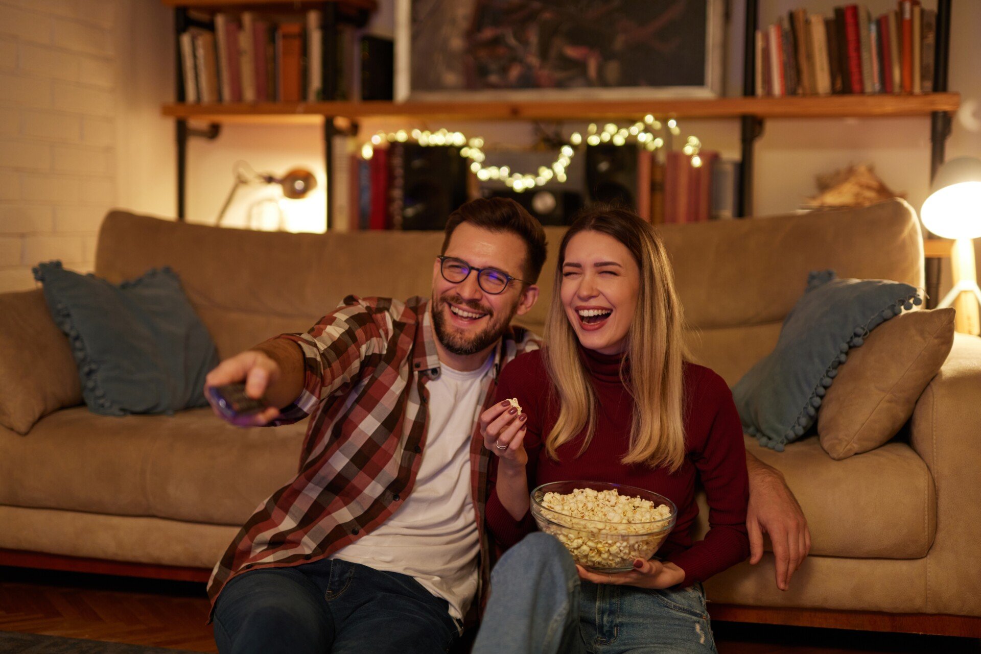 Young,Romantic,Couple,Watching,Tv,At,Home hanging out couple