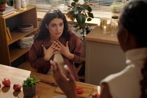 When Is Autism Used As An Excuse And When Is It An Explanation? 21 Two women having a disagreement with one blaming the other.