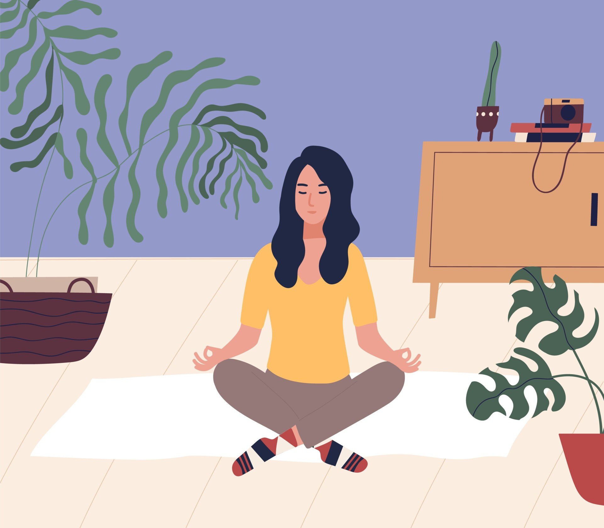 woman with closed eyes sitting cross legged on floor and meditating