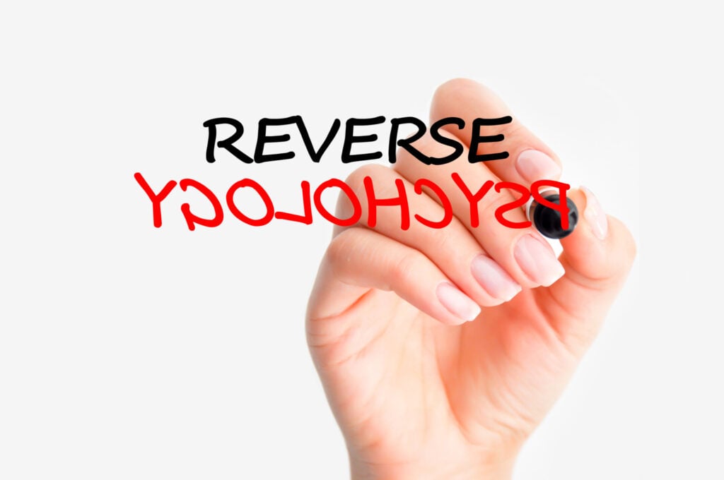 Reverse Psychology: What Is It, And Does It Work? 1 a hand writing reverse psychology
