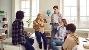 Transferability In Qualitative Research 21 A group of adolescent students having a discussion in the classroom.